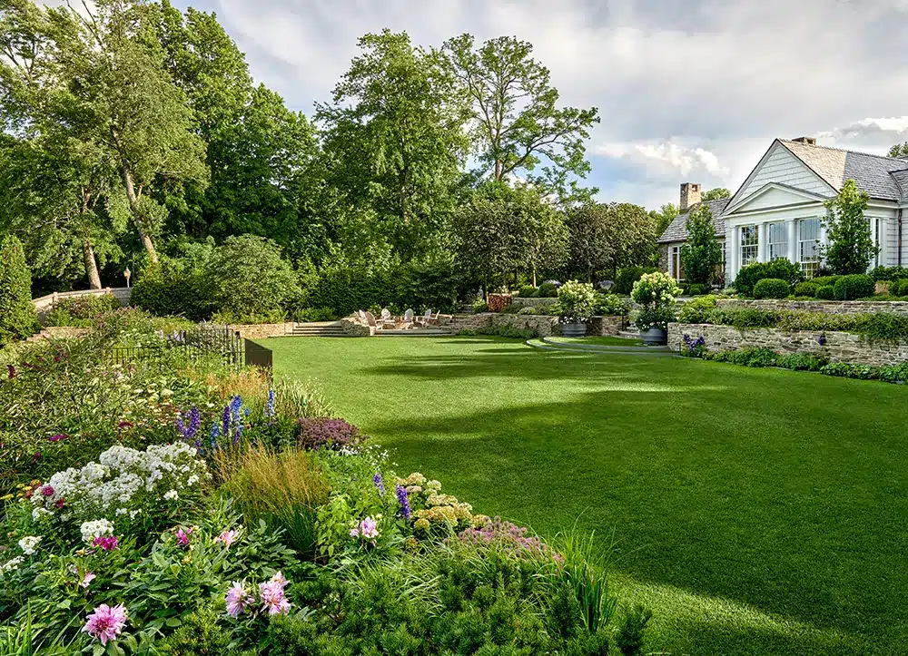 A home with a large lawn and flowers.
