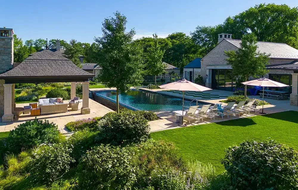 An aerial view of a backyard with a pool.