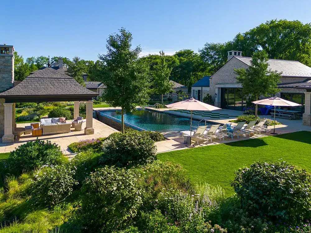 An aerial view of a backyard with a pool.