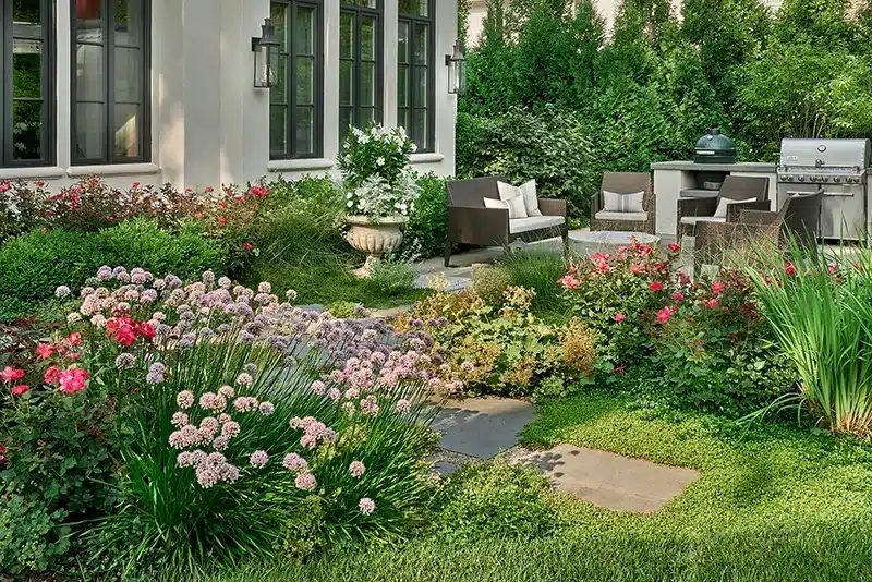 A backyard with a large patio and a grill.