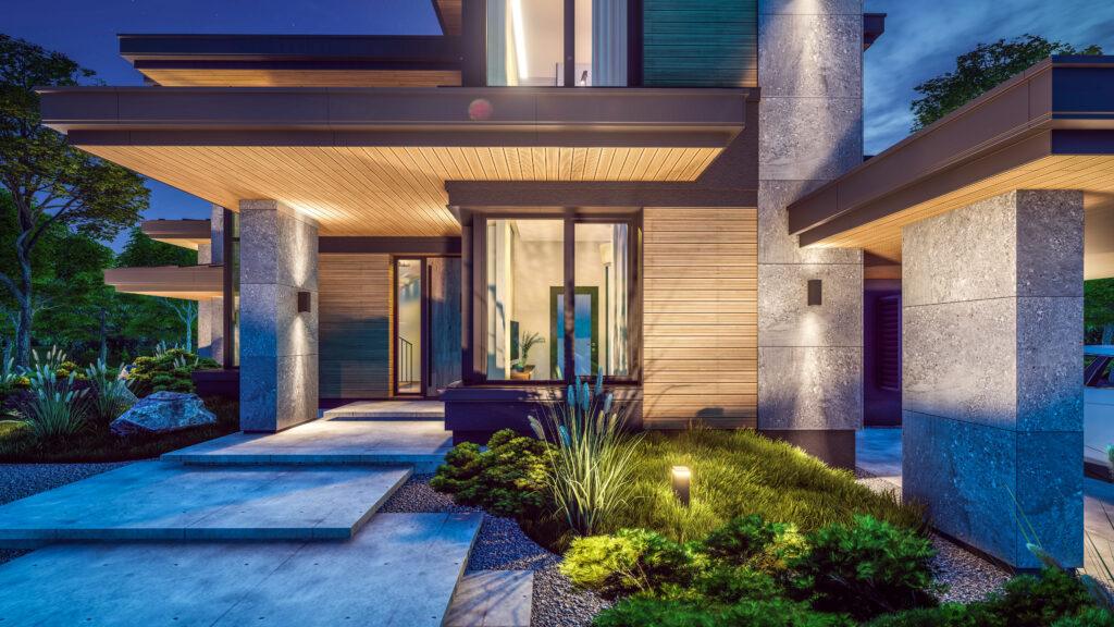 A luxury home with beautiful landscape lighting illuminating front garden and path