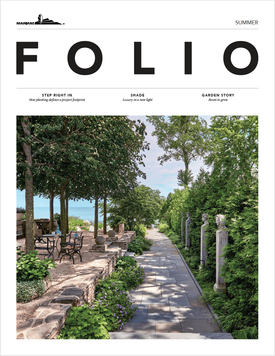 Magazine cover featuring a landscaped garden path with stone pillars, outdoor seating, and trees under a clear sky. The issue is titled "FOLIO" and labeled as the summer edition.
