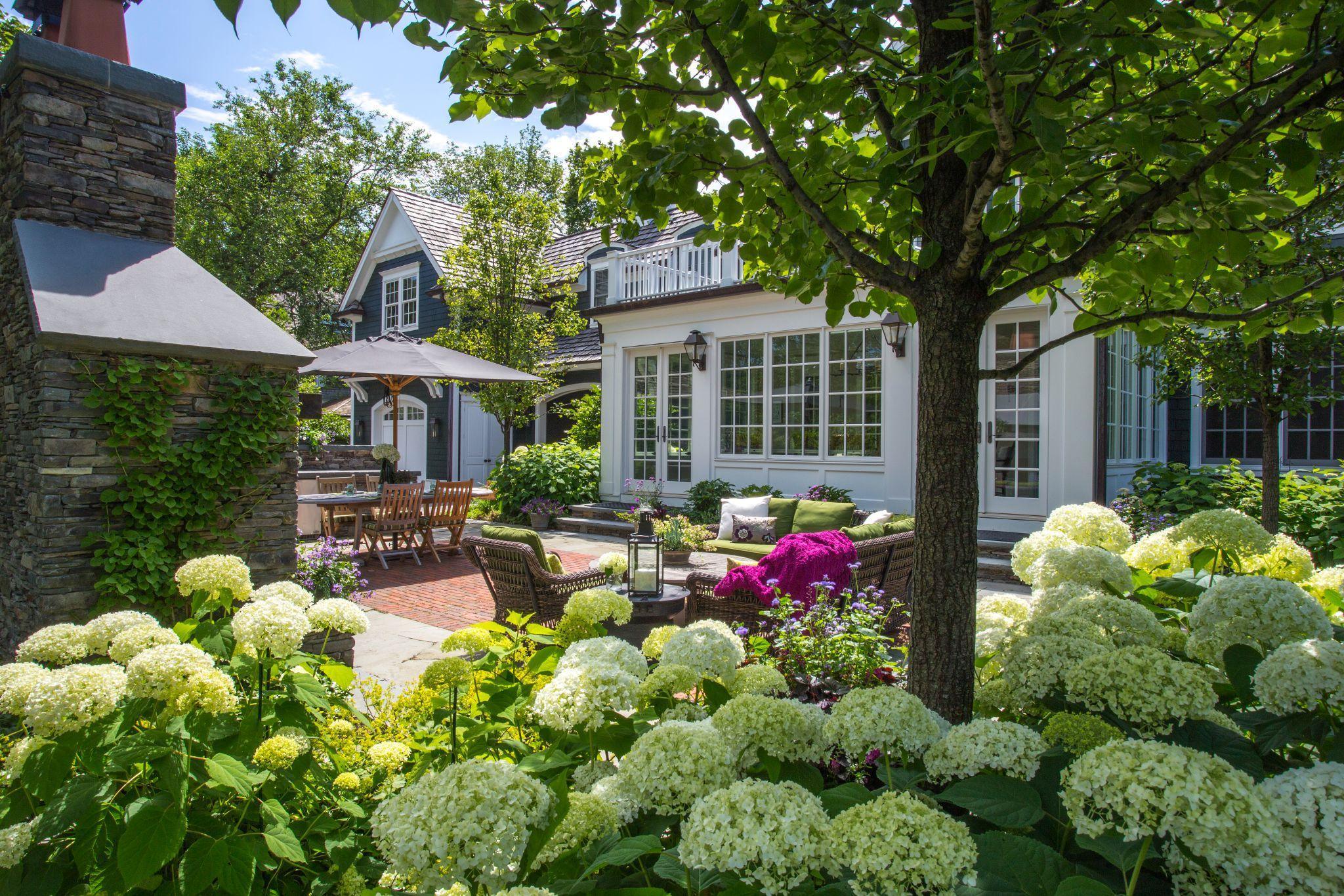 Private city garden with flowering perennials and gravel terrace